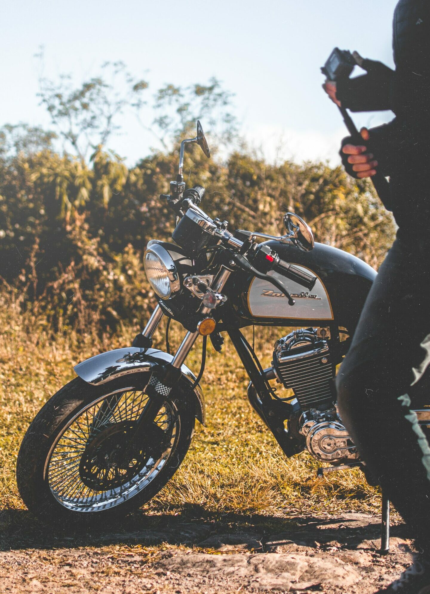 man beside a black and white motorcycle